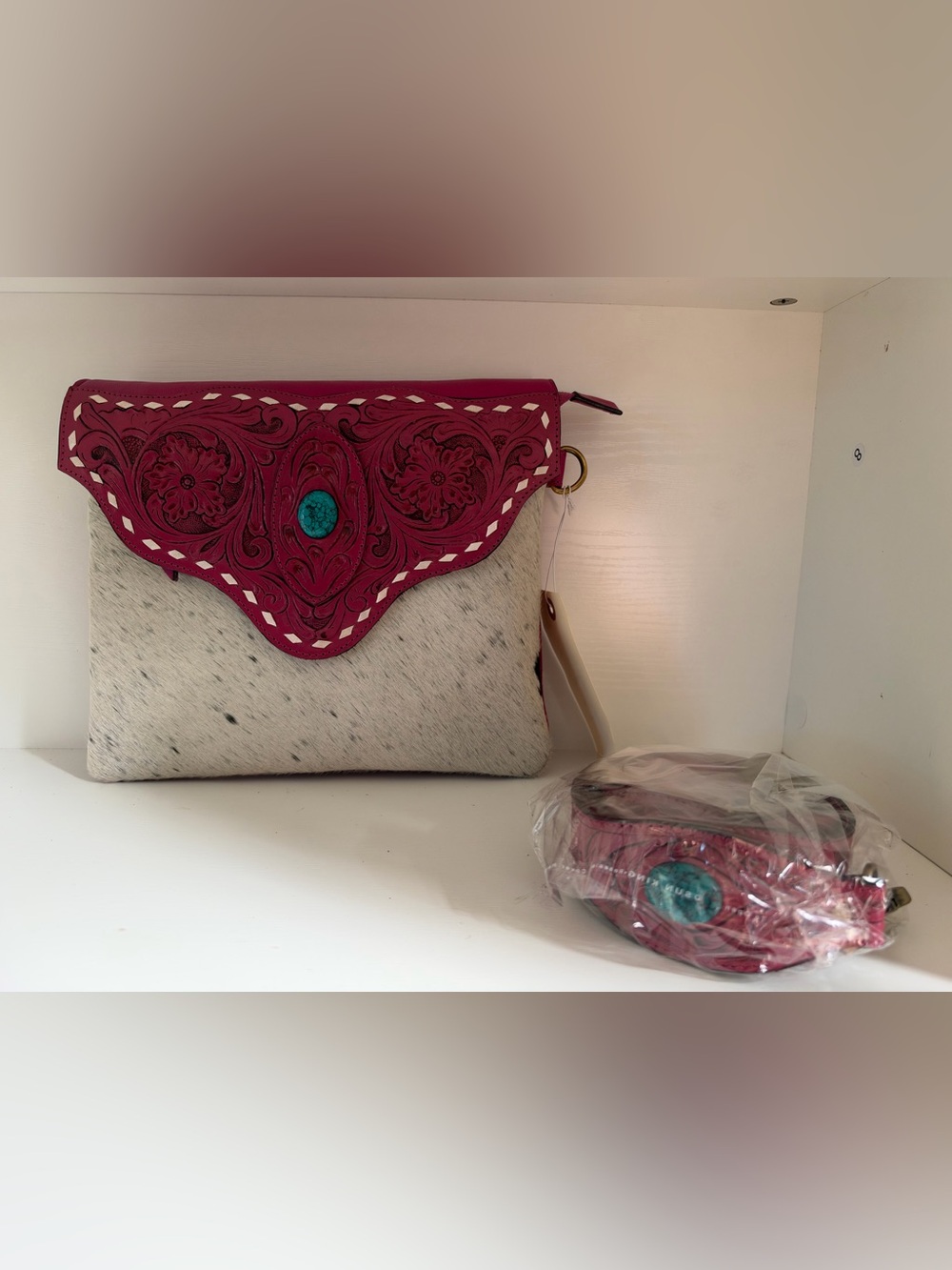 pink tooled flap cowhide crossbody bag with turquoise accent